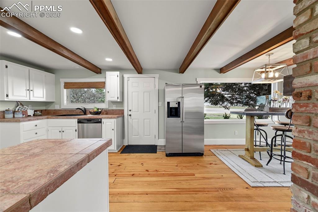 Image 8 of 50: Eat-in Kitchen with Walk-out to the back.