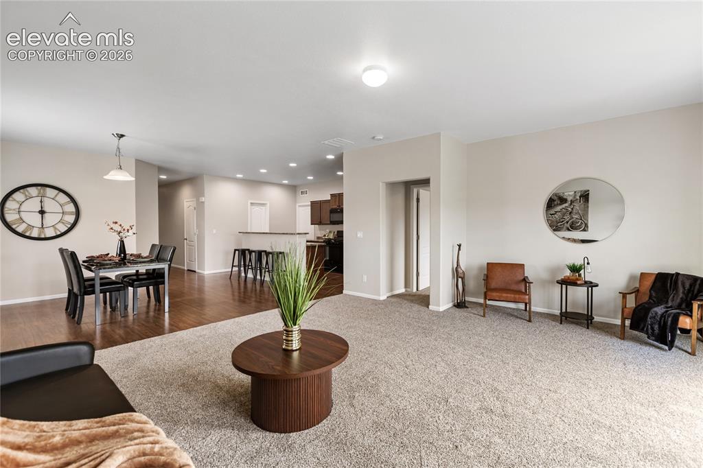 Image 13 of 46: Living room/dining room is spacious and features brand new carpet with upgr