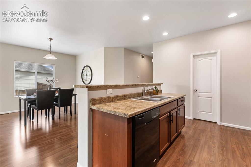 Image 20 of 46: The kitchen features this island with breakfast bar.  There is also a walk-