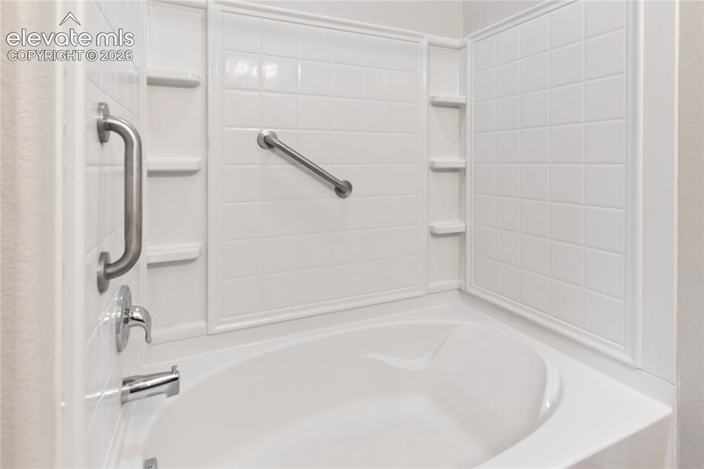 Image 31 of 46: Primary bathroom features this oversized tub/shower