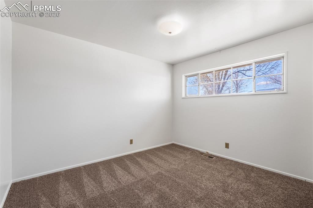 Image 11 of 18: Bedroom 1 featuring new carpet