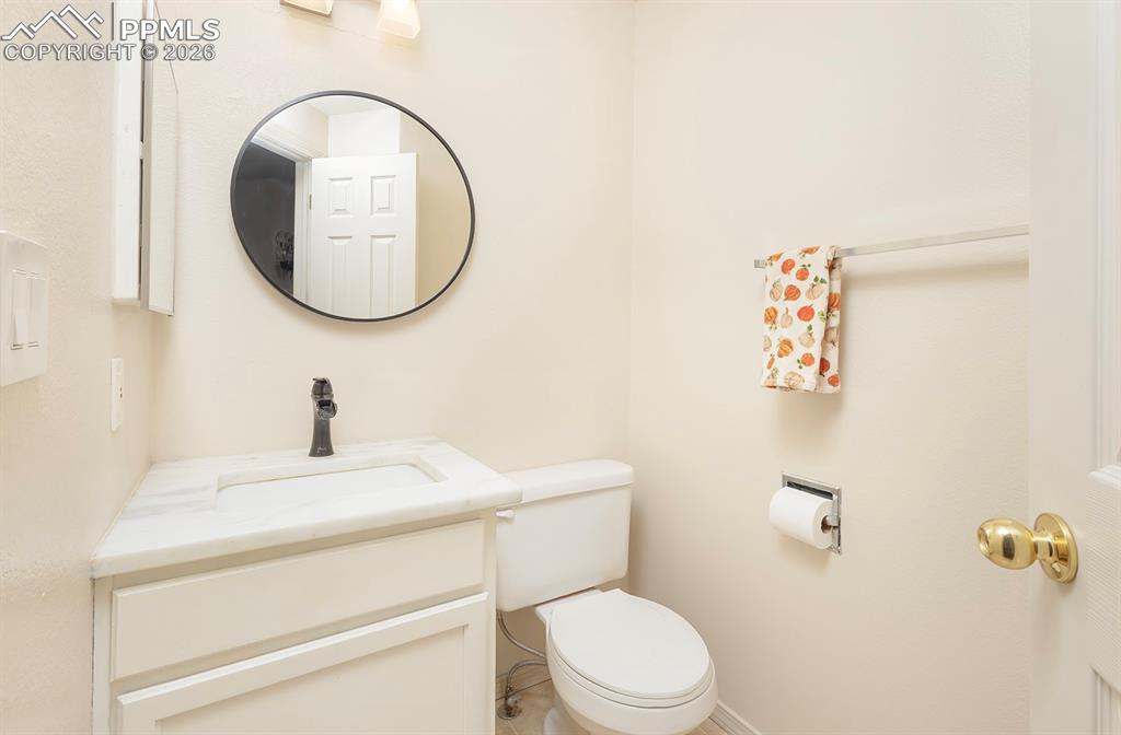 Image 10 of 35: Bathroom featuring a white vanity with an integrated sink, a white stone co