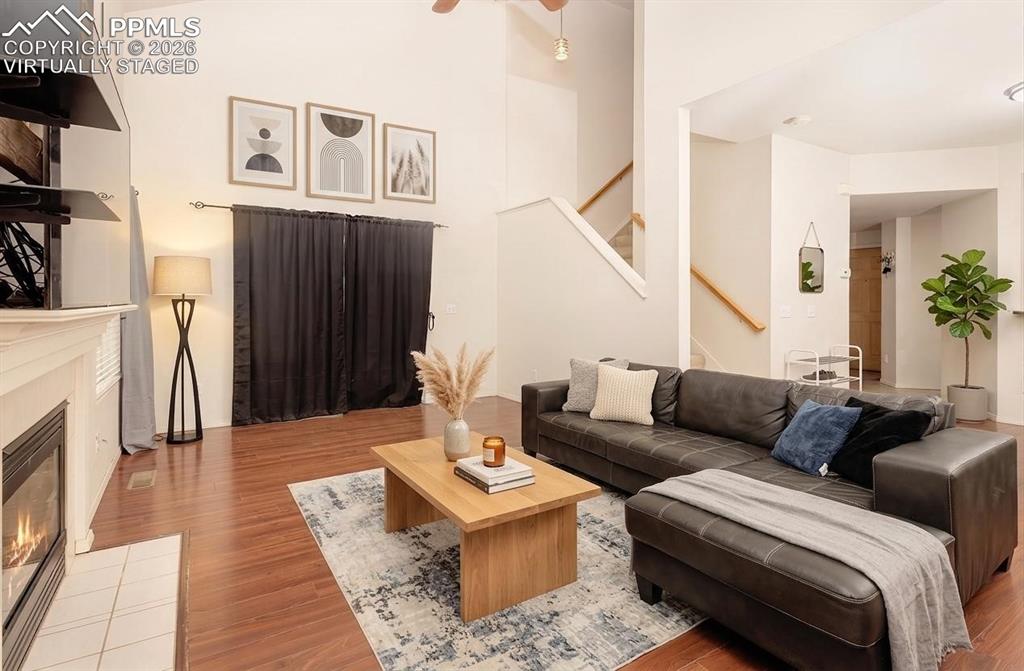 Image 11 of 35: Virtually Staged Living area featuring a vaulted ceiling and rich wood-fini