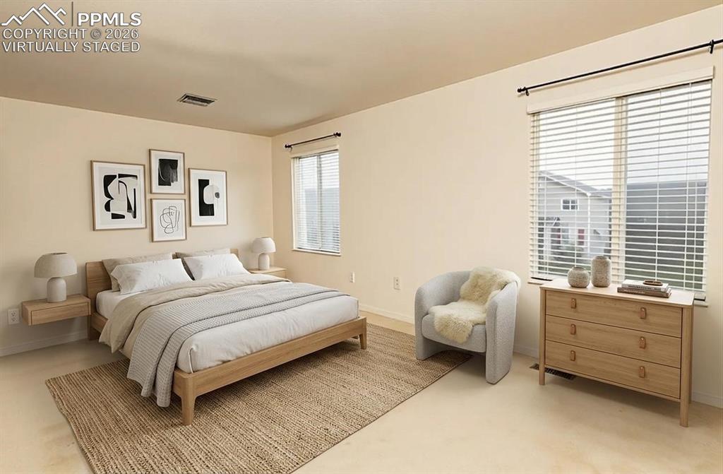 Image 13 of 35: Virtually Staged Bedroom featuring light-colored walls, carpet flooring, a 
