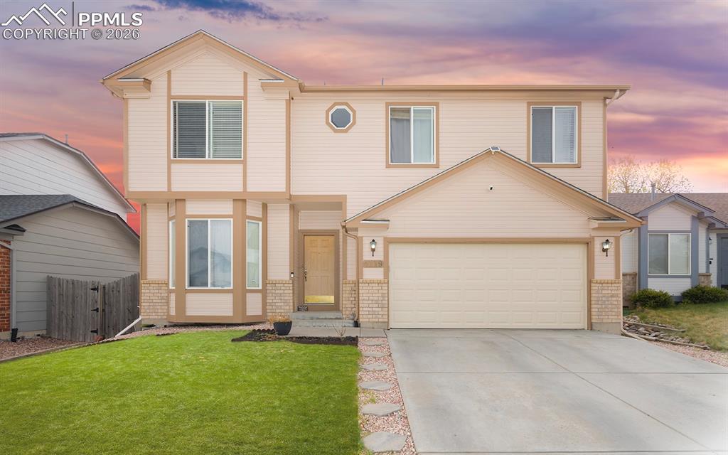 Image 22 of 35: Two-story residence featuring light-colored siding with contrasting trim ac