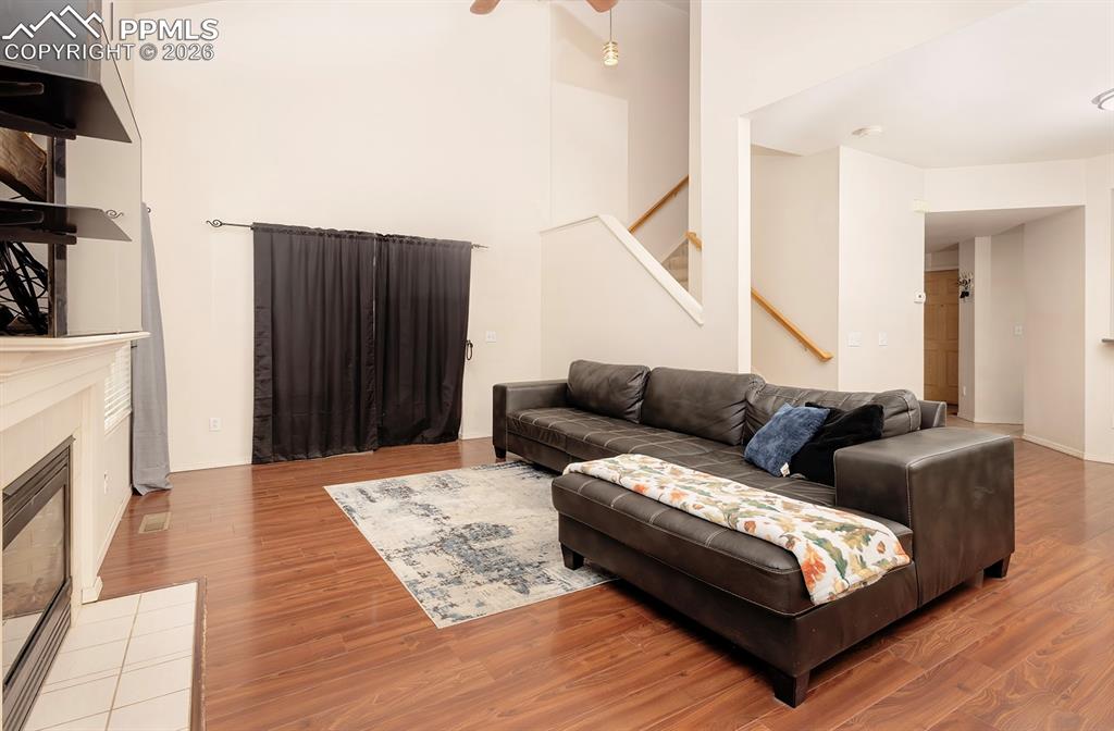 Image 27 of 35: Open concept living area featuring high vaulted ceilings, wood-finish floor