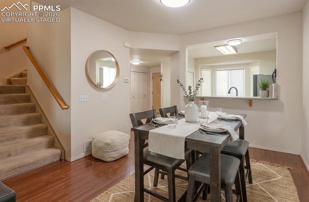Image 3 of 35: Virtually Staged Wood-finish flooring anchors this dining area, featuring a