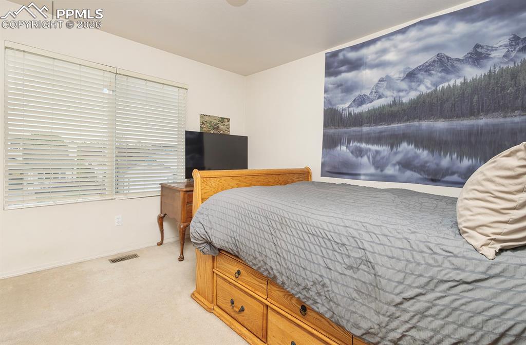 Image 31 of 35: Bright room featuring dual windows with horizontal blinds, neutral wall pai