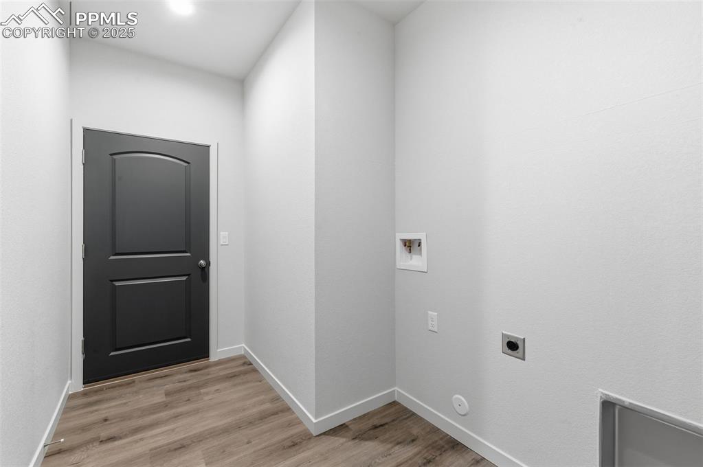 Image 24 of 24: Laundry area featuring washer hookup, light wood-style floors, and hookup f