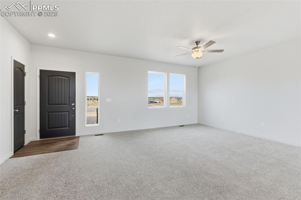 Image 3 of 24: Unfurnished room featuring carpet floors and ceiling fan