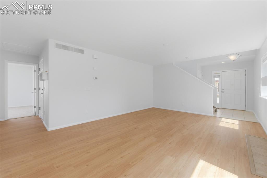 Image 12 of 34: Open-concept living space with light wood-look LVP flooring