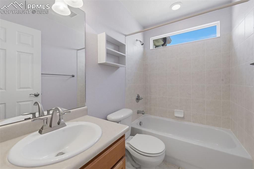 Image 19 of 34: Main level Full Bathroom featuring a single vanity with an oval sink, a lig
