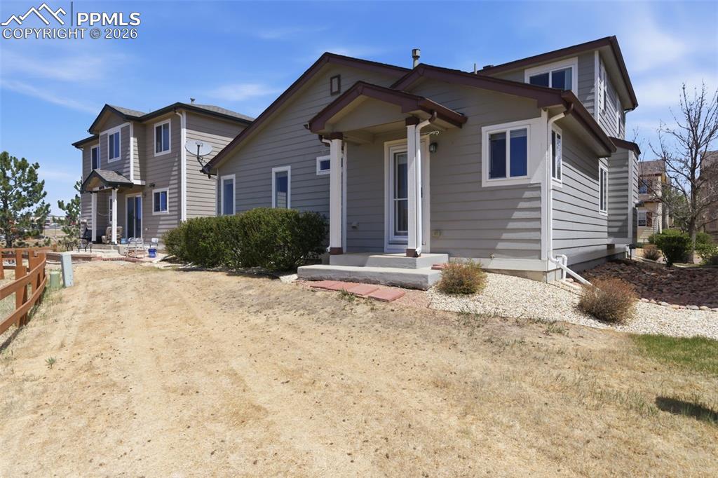 Image 26 of 34: Siding exterior with white trim and a covered entry