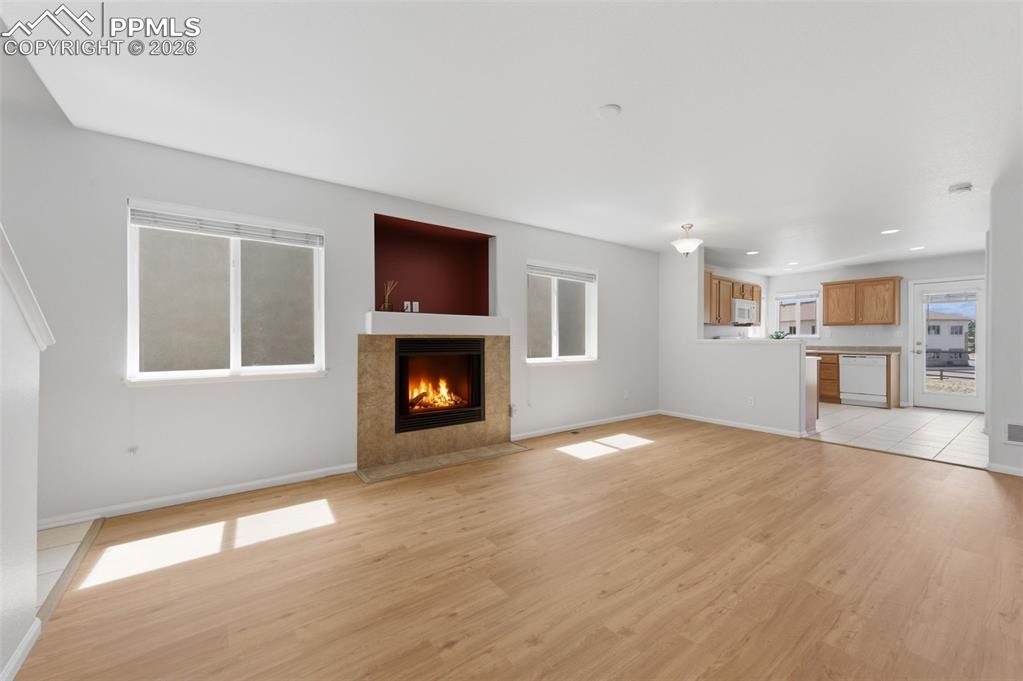 Image 3 of 34: Great Room, Fireplace, Living Room, Dining area looking to Kitchen