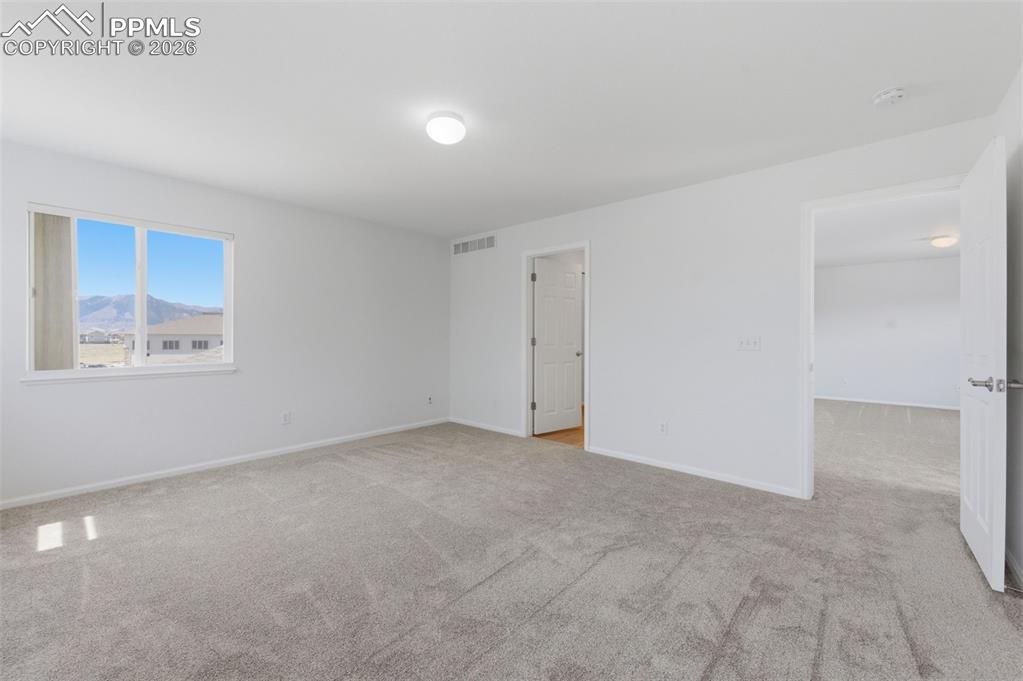 Image 7 of 34: Primary Bedroom with a view of Pikes Peak