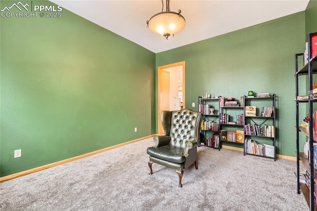 Image 14 of 50: Sitting room with carpet flooring and baseboards