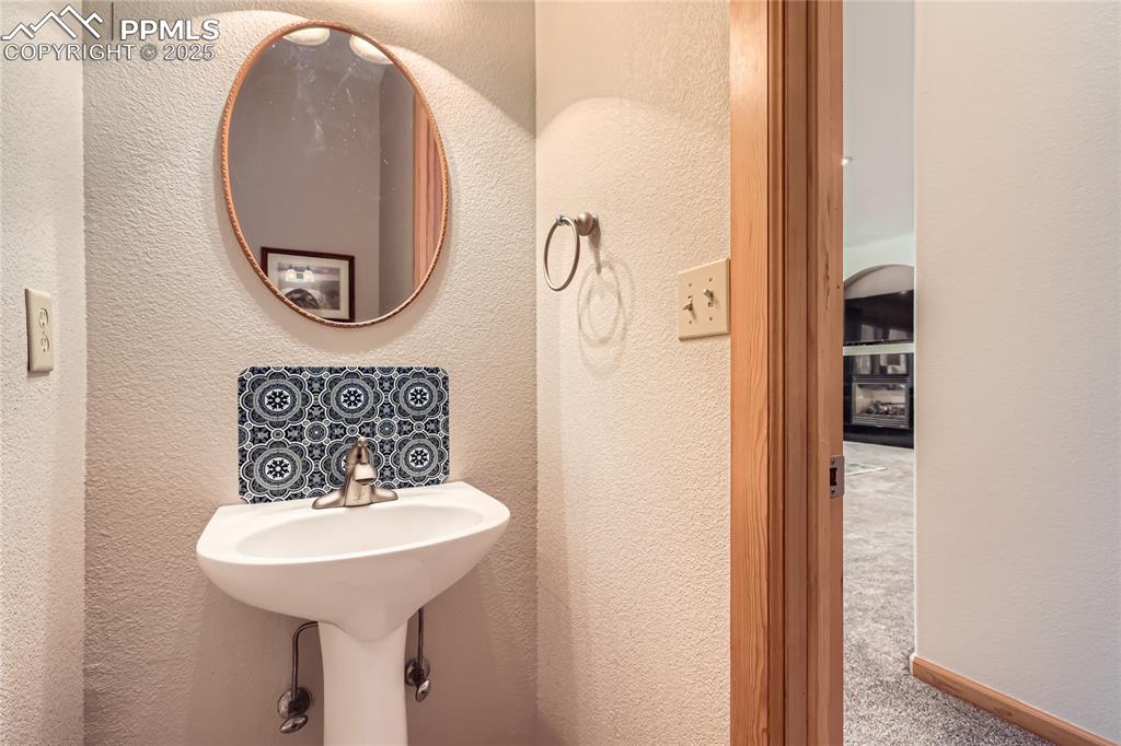 Image 16 of 50: Bathroom with a textured wall