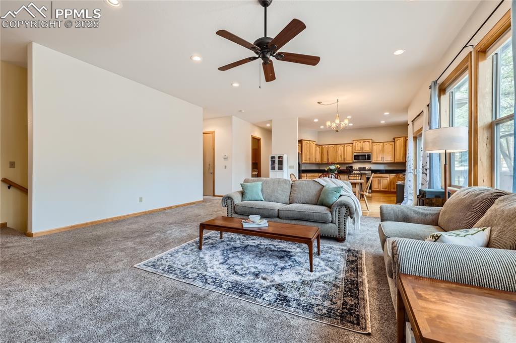 Image 21 of 50: Living room featuring recessed lighting, light colored carpet, ceiling fan 