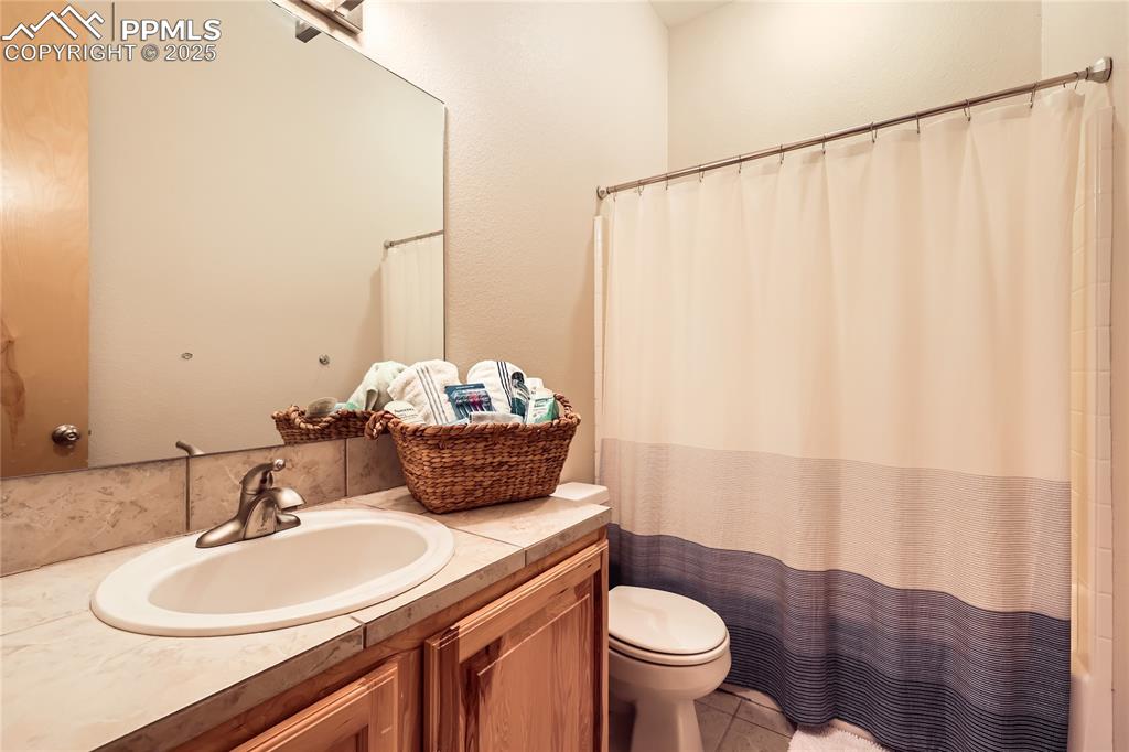 Image 29 of 50: Full bath featuring tile patterned floors, toilet, and vanity