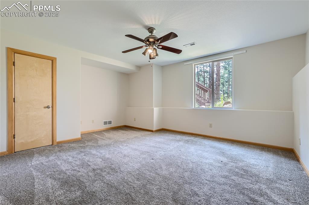 Image 32 of 50: Unfurnished room with visible vents, carpet flooring, baseboards, and ceili