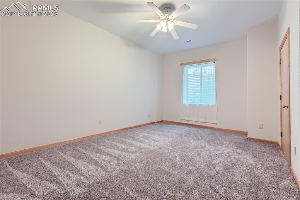 Image 34 of 50: Unfurnished room with baseboards, carpet floors, visible vents, and a ceili