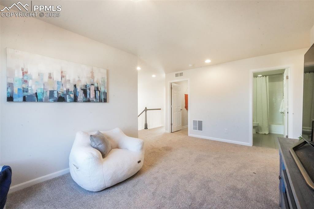 Image 20 of 50: Sitting room featuring carpet floors, recessed lighting, and an upstairs la