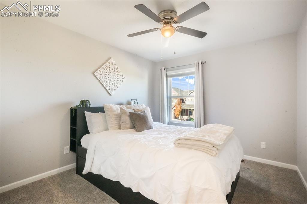 Image 37 of 50: Carpeted bedroom featuring baseboards and ceiling fan