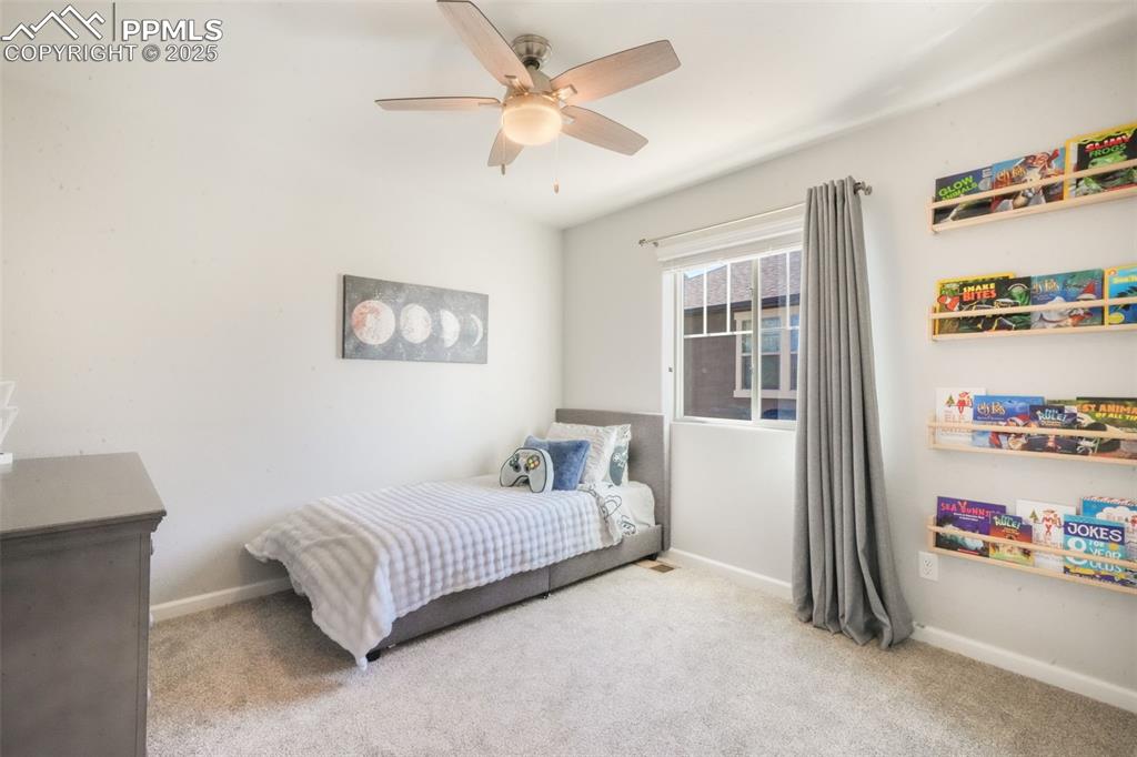 Image 40 of 50: Bedroom featuring light colored carpet and ceiling fan