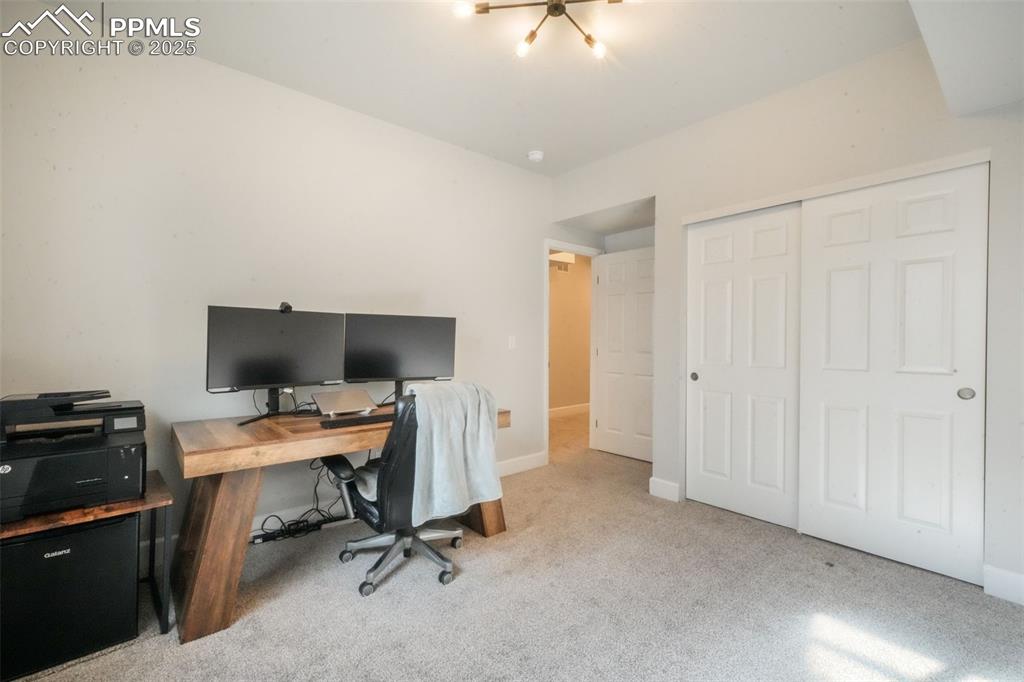 Image 41 of 50: Home office with carpet floors and baseboards