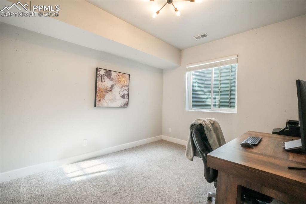 Image 42 of 50: Home office featuring carpet and baseboards