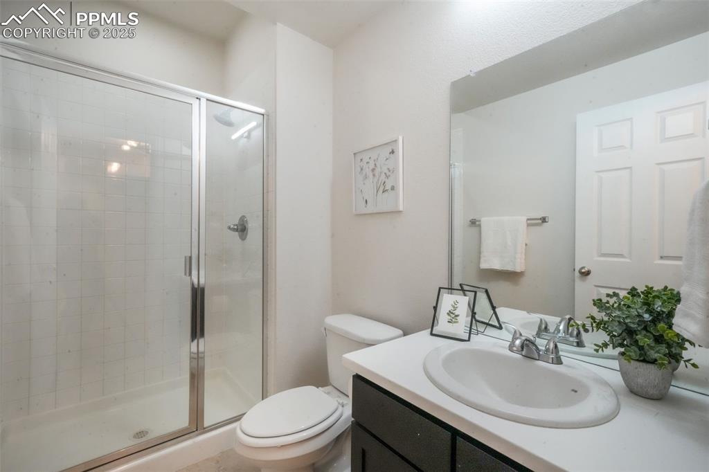 Image 43 of 50: Full bath with vanity and a shower stall