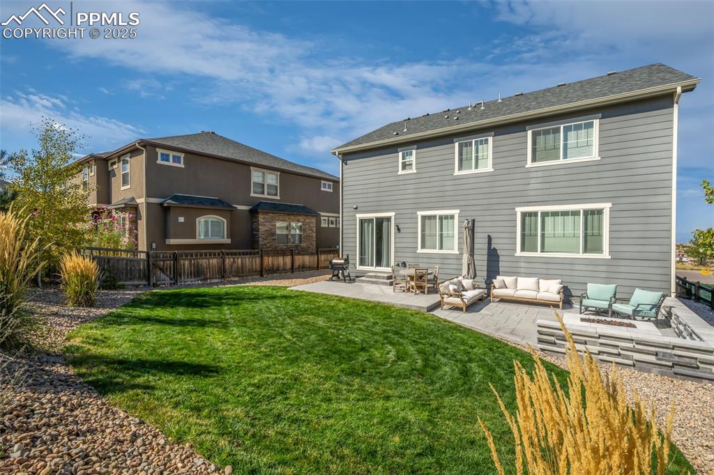 Image 48 of 50: Back of property featuring a patio and an outdoor hangout area