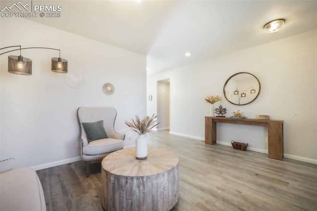 Image 5 of 50: Sitting room featuring wood finished floors and recessed lighting