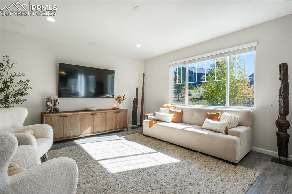 Image 8 of 50: Living area featuring wood finished floors and recessed lighting