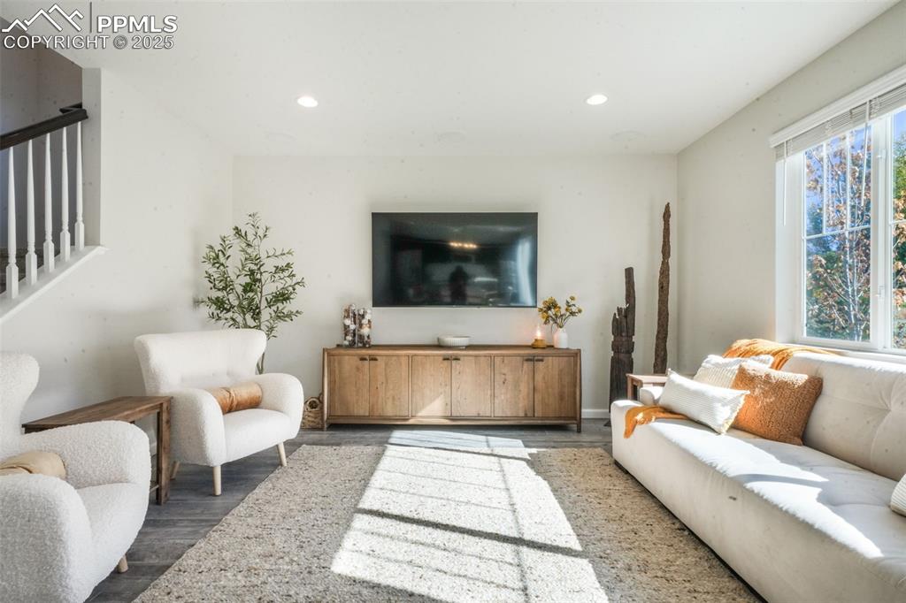 Image 9 of 50: Living area featuring wood finished floors and recessed lighting