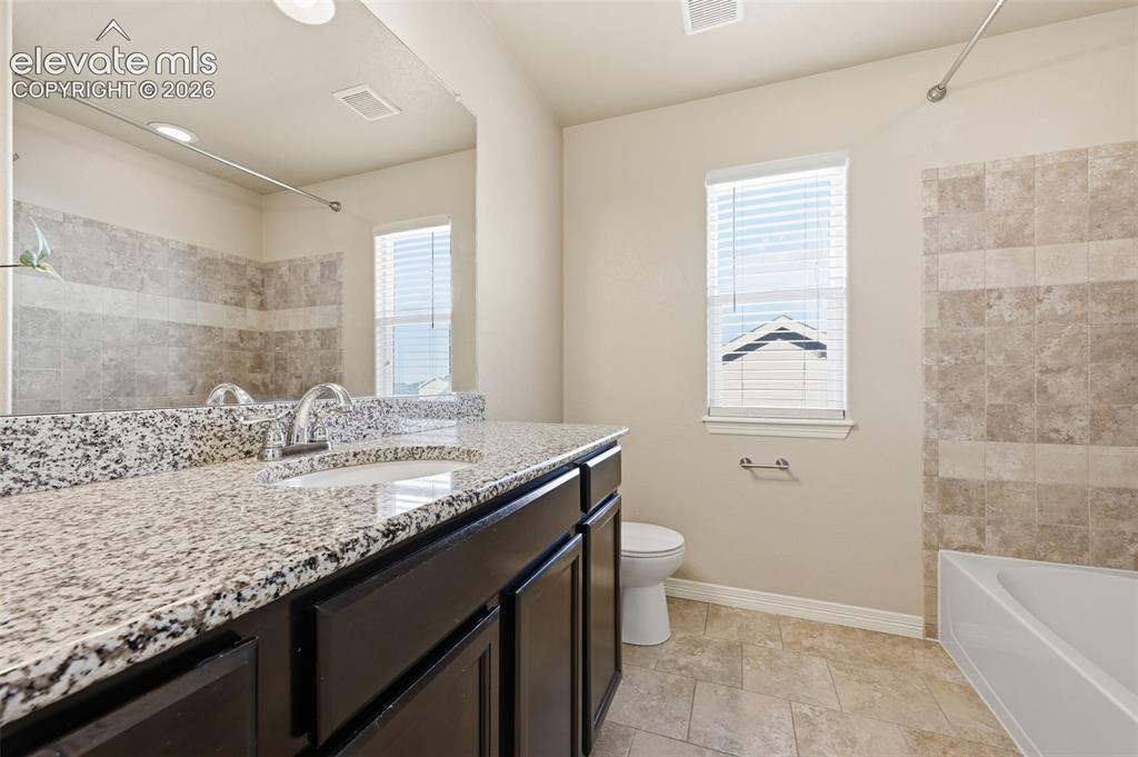 Image 17 of 37: Big soaking tub & stand-up shower in primary bath