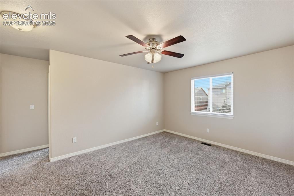 Image 18 of 37: Sunny living room next to kitchen w/ easy access to the back patios & yard