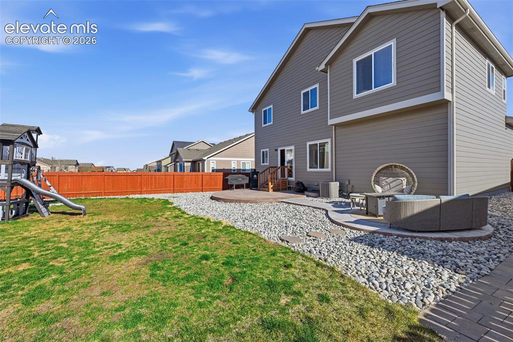 Image 3 of 37: Enjoy the covered front porch, low-maintenance xeriscaped lawn & attached t