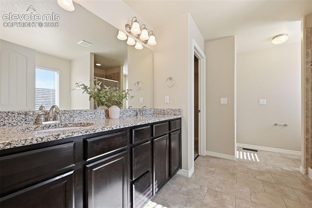 Image 9 of 37: Dining room with stylish upgraded light fixture & beautiful engineered hard