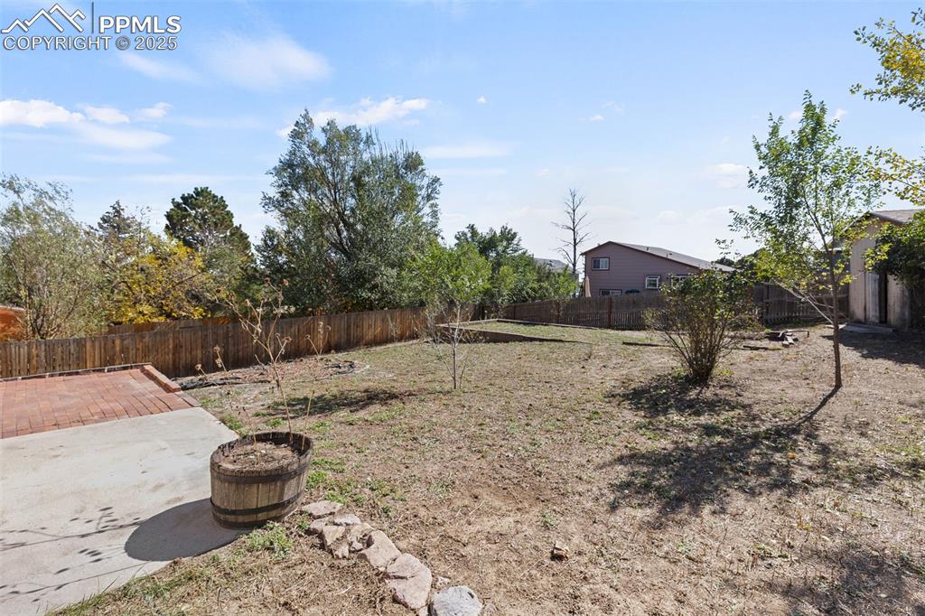 Image 20 of 32: Backyard w/storage shed