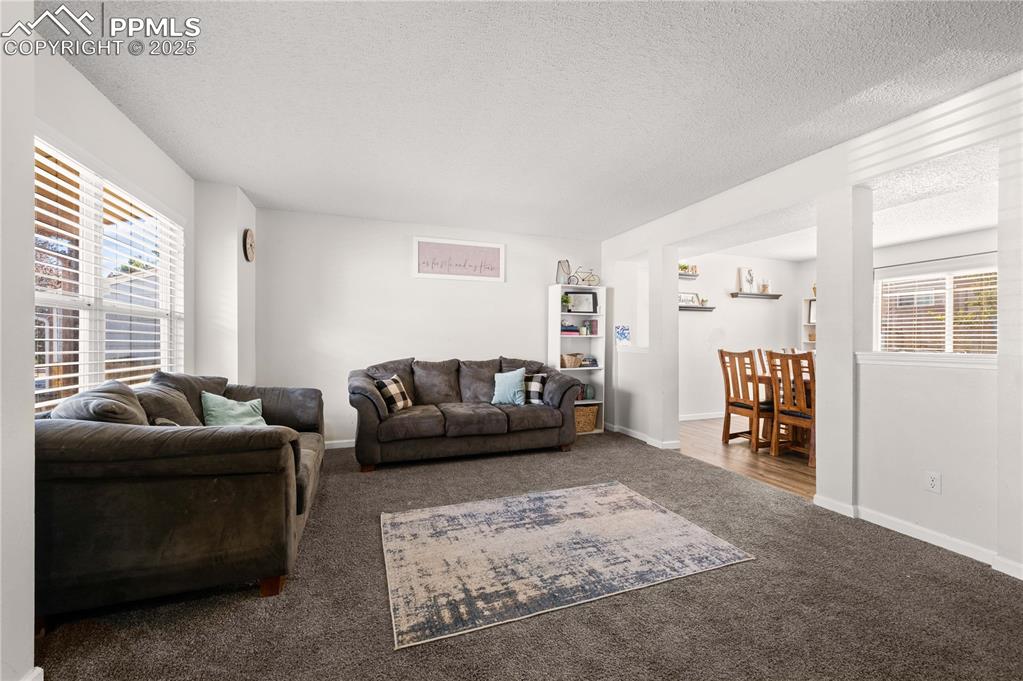 Image 16 of 30: Cozy family room with versatile layout options, showcasing plush carpeting,