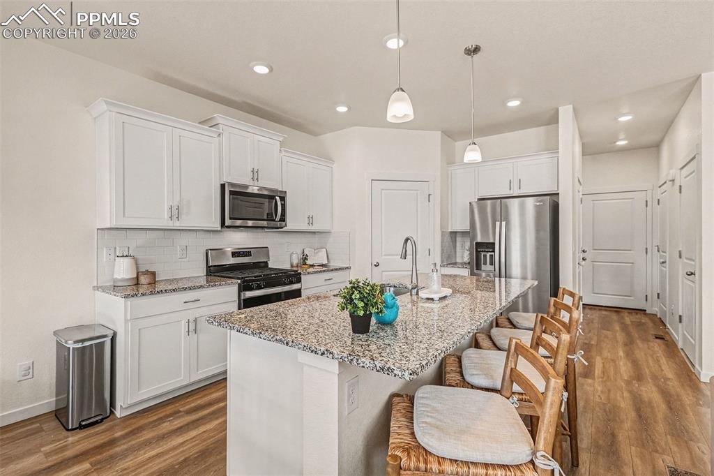 Image 6 of 22: Kitchen bar/island for additional dining