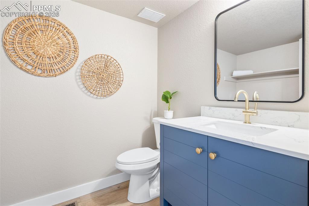 Image 14 of 26: Half bathroom featuring vanity and light wood finished floors