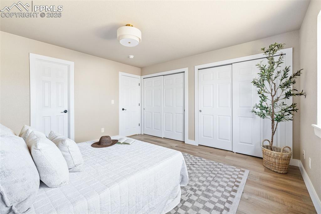 Image 18 of 26: Bedroom with two closets and light wood-type flooring