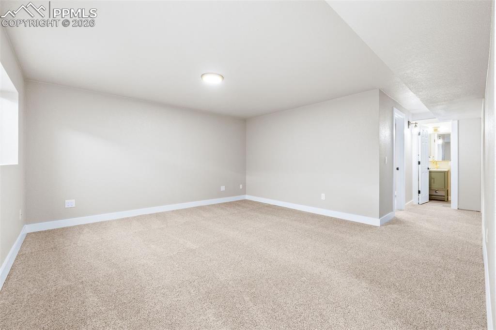 Image 22 of 26: Spare room featuring light colored carpet and baseboards
