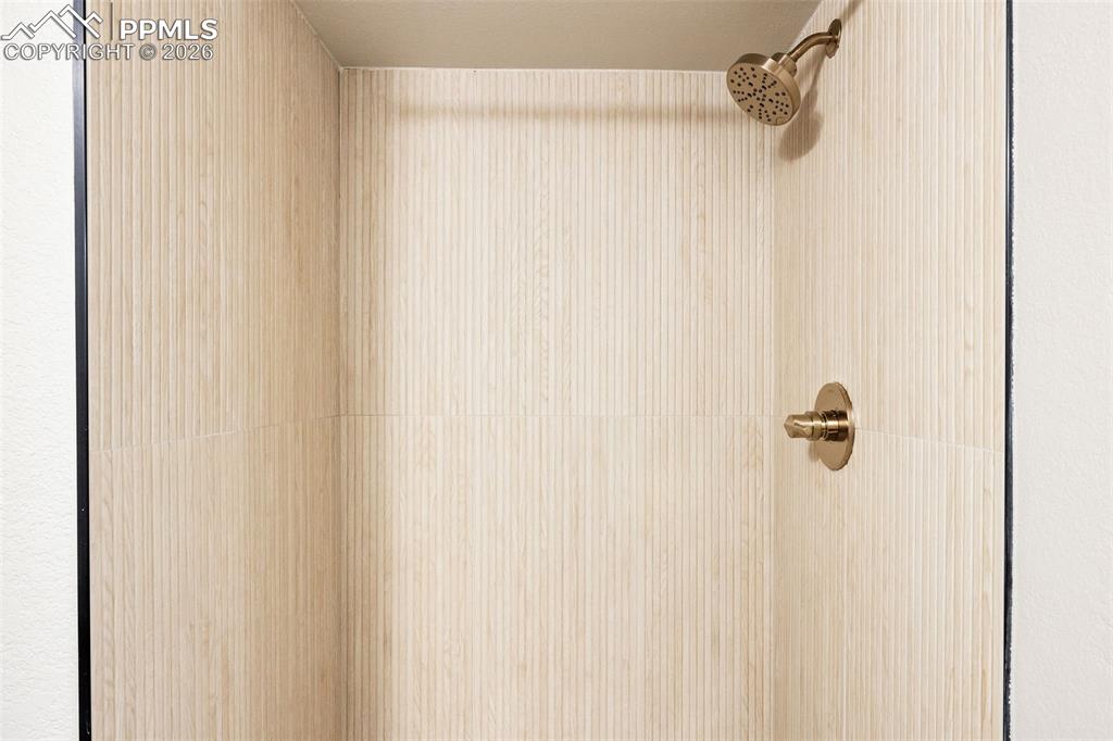 Image 26 of 26: Bathroom view of a tile shower