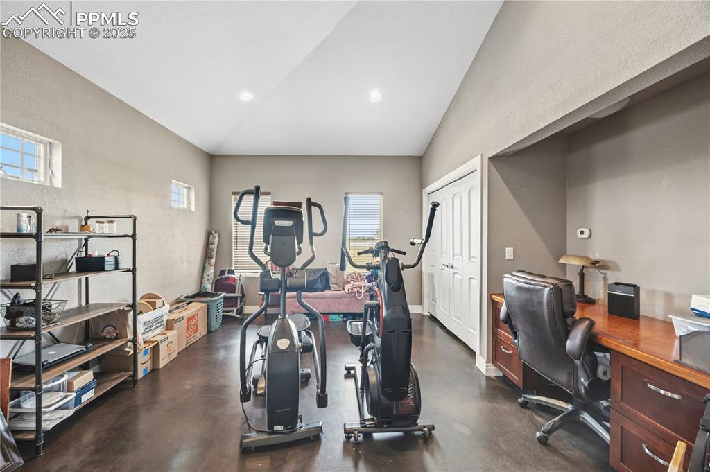 Image 12 of 40: Exercise room with plenty of natural light, recessed lighting, and high vau