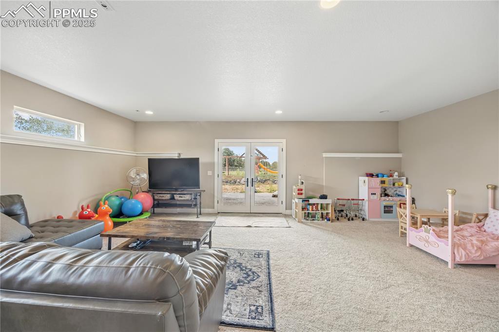 Image 16 of 40: Living room featuring plenty of natural light, french doors, carpet floors,