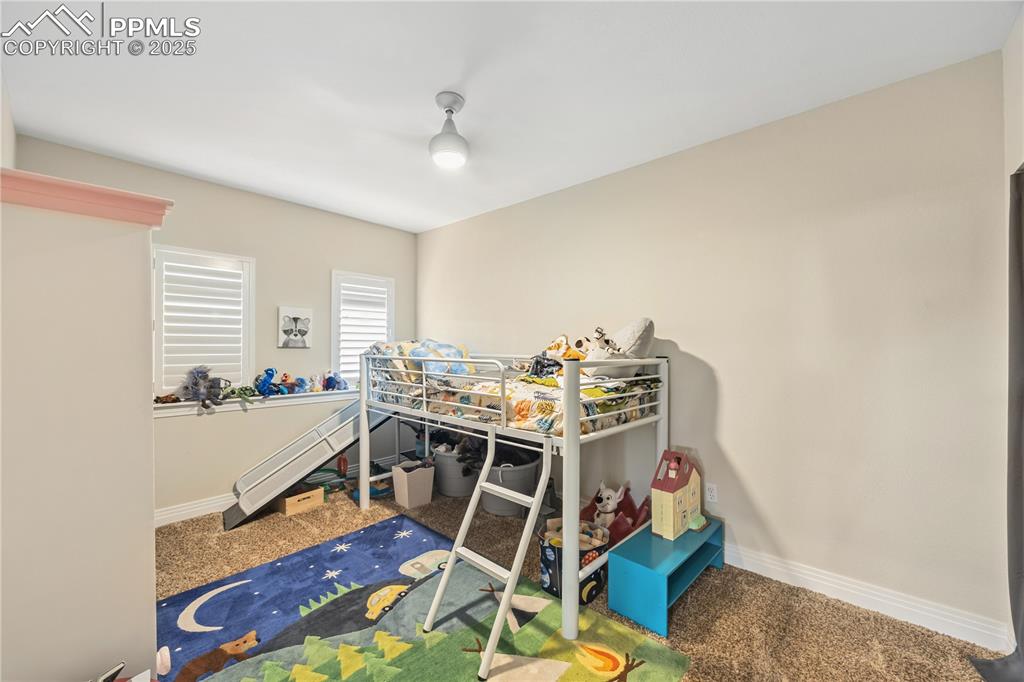Image 19 of 40: Bedroom with carpet flooring
