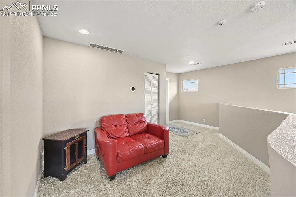 Image 22 of 40: Sitting room featuring light carpet and baseboards